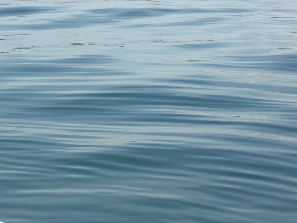 Light moving across water like falling rain